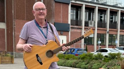 Cllr Andy Semple with guitar