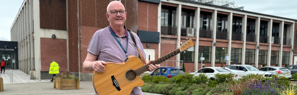 Cllr Andy Semple with guitar