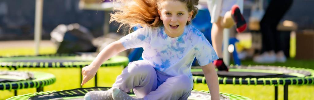 child on roundabout at wellbeing festival